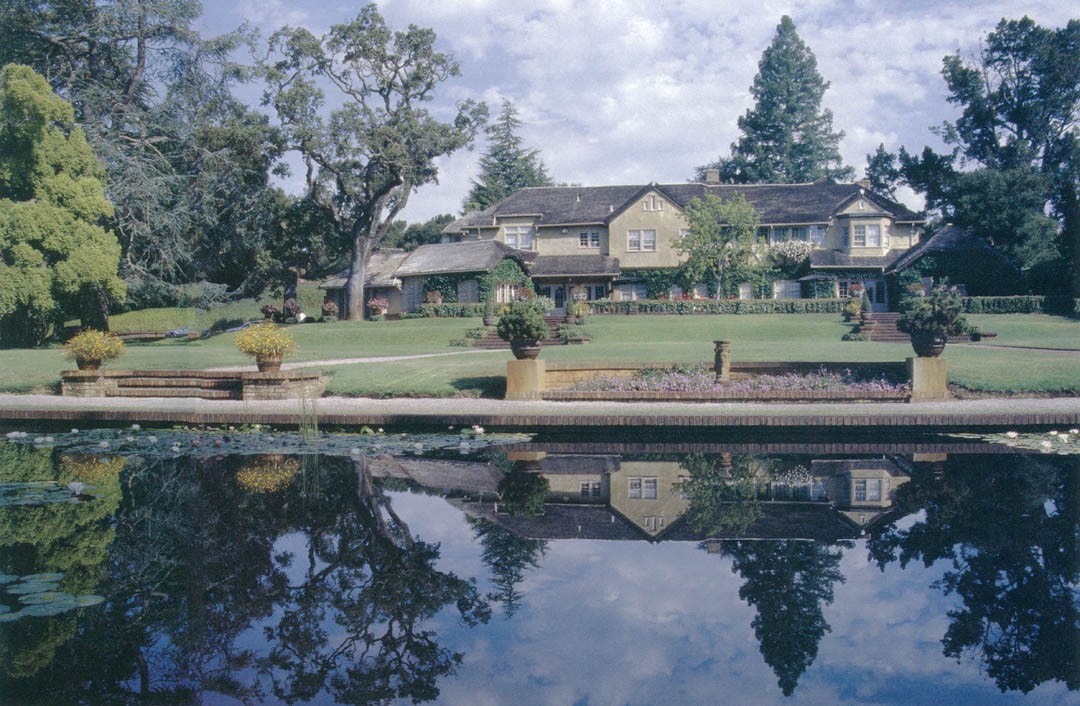 The water garden at Green Gables, a long reflecting pool stretched across the hillside terminating in an arched Roman-style dam, the designed estate landscape descending from the house
