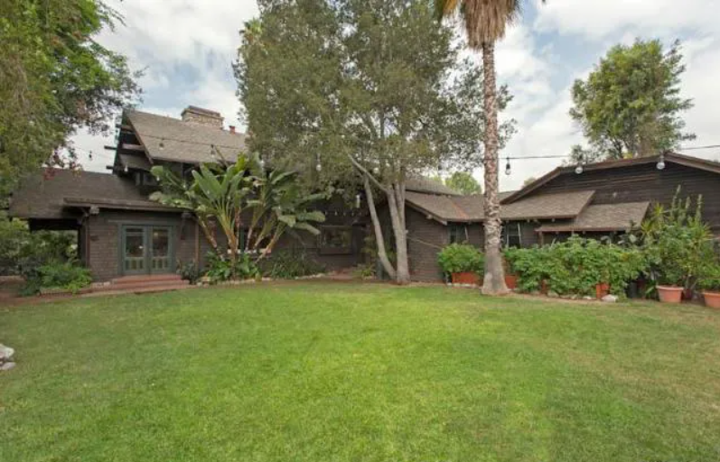 The backyard of the Louise T. Halsted House, showing the rear elevation and a small patio area.