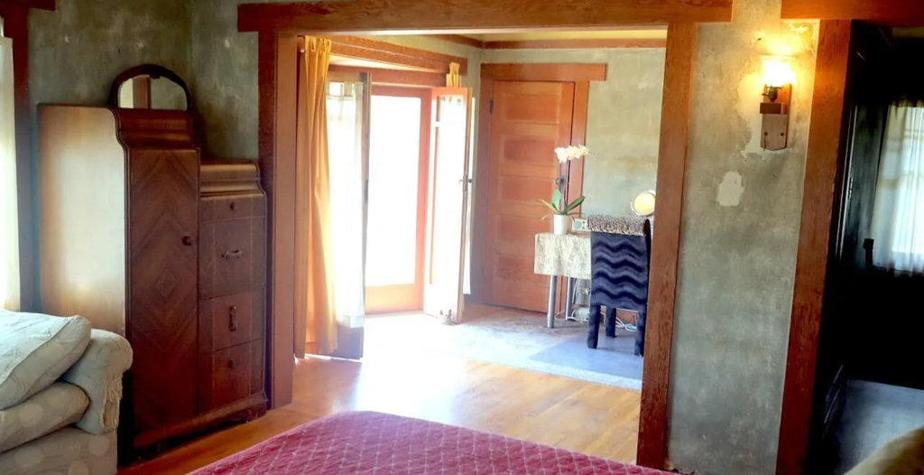 A photograph of the master bedroom of the Miss Lucy E. Wheeler House, showing its built-in wardrobe and window seat.