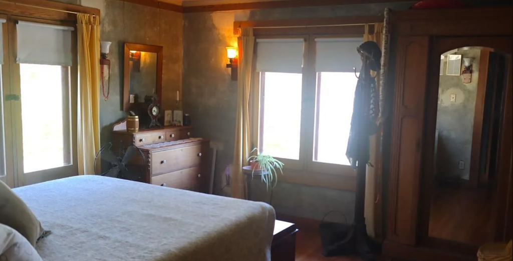 A photograph of a second bedroom in the Miss Lucy E. Wheeler House, showing its built-in wardrobe and window seat.