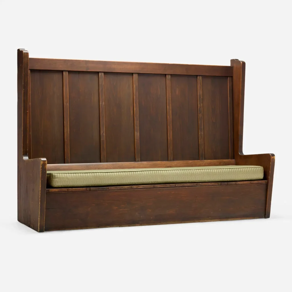 Wooden bench with vertical slat back and upholstered seat from the Dr. Arthur A. Libby House by Greene & Greene, featuring characteristic Arts and Crafts joinery and proportions that demonstrate their early custom furniture design and comprehensive approach to residential environments.