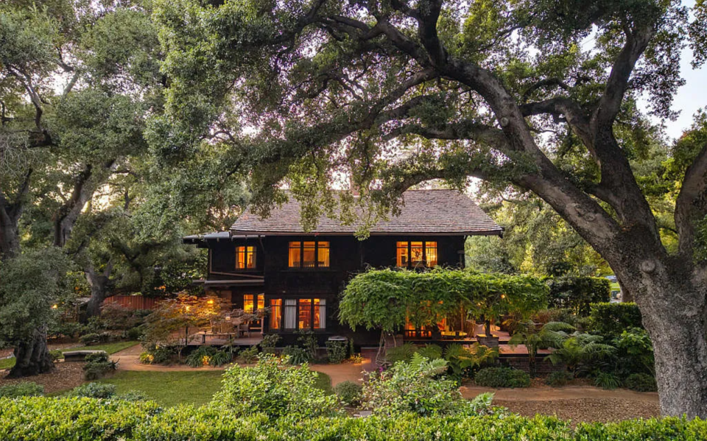 Distant backyard view of the Louise C. Bentz House showing full property, patio area, pergola, and mature landscaping