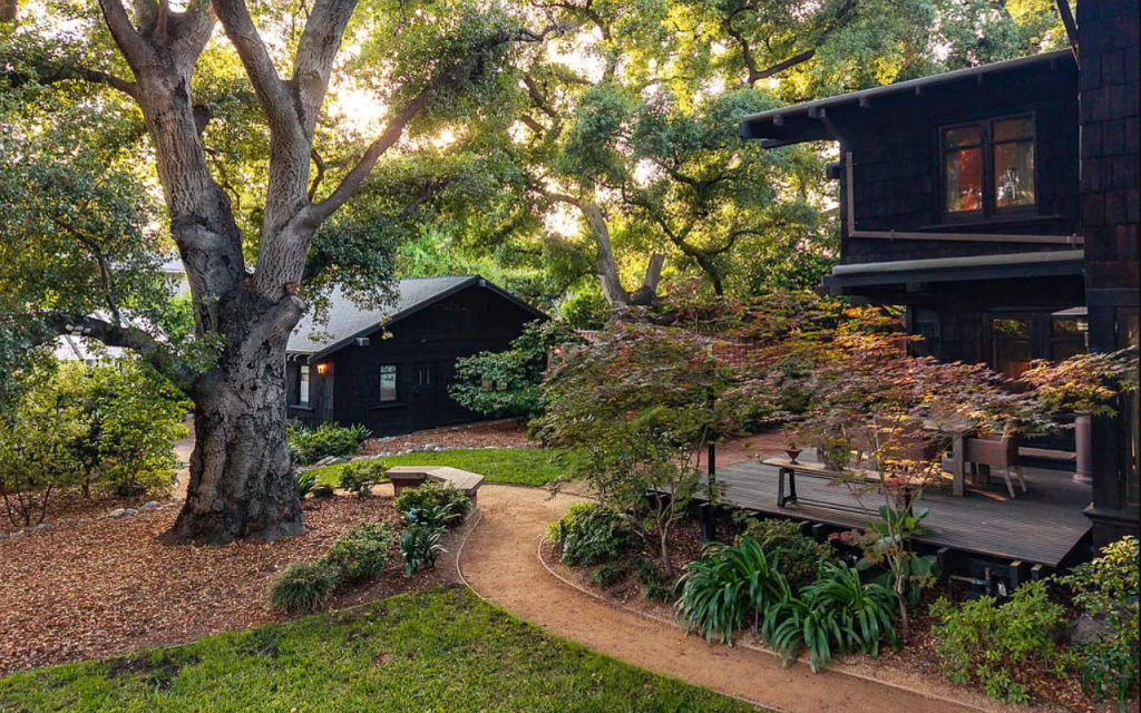 Distant backyard view of garage at the Louise C. Bentz House showing Craftsman architecture and surrounding landscape