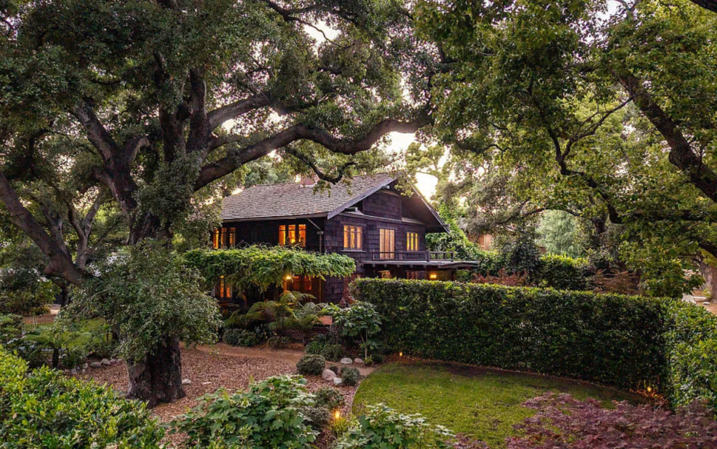 Distant side yard view of the Louise C. Bentz House showing Craftsman architecture, wood siding, and mature landscaping