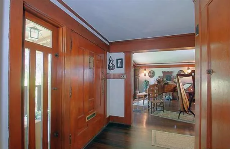 Gallery of two interior photographs showing the entryway of the Josephine van Rossem House No. 2 (1904) by Greene & Greene, featuring rich wood paneling, built-in cabinetry, and carefully designed openings that demonstrate the California House concept's interior planning and craftsmanship quality in Pasadena, California.