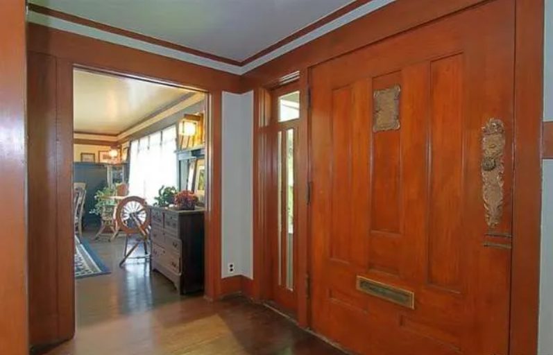 Gallery of two interior photographs showing the entryway of the Josephine van Rossem House No. 2 (1904) by Greene & Greene, featuring rich wood paneling, built-in cabinetry, and carefully designed openings that demonstrate the California House concept's interior planning and craftsmanship quality in Pasadena, California.