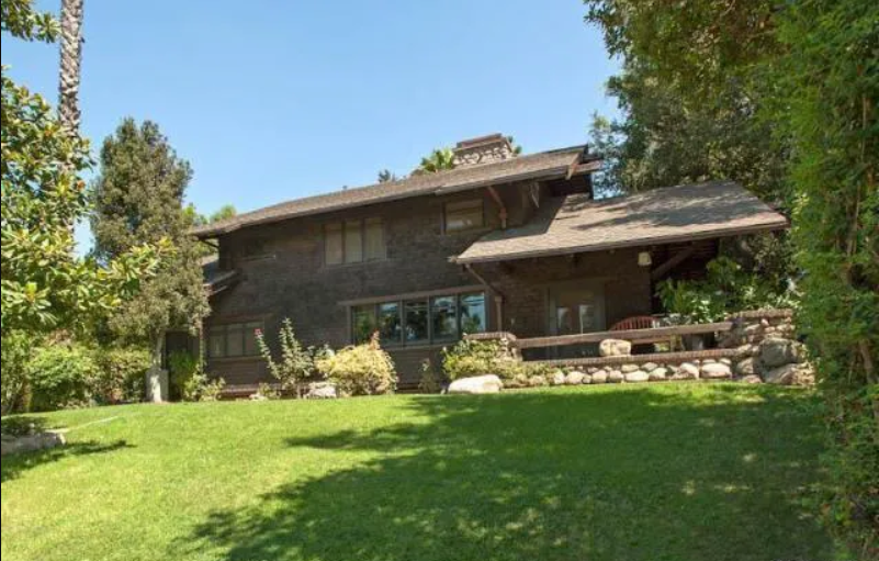 A contemporary front view of the one-and-a-half-story Louise T. Halsted House, showing its shingle siding and prominent roofline.