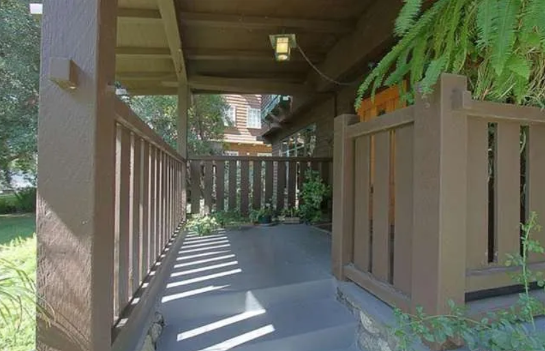 Gallery of four contemporary photographs showing the Josephine van Rossem House No. 2 (1904) by Greene & Greene, including driveway approach view, front door entrance detail, full front elevation, and covered front porch, demonstrating the California House concept with cedar shingle siding, cobblestone foundation, and mature landscape integration in Pasadena, California.