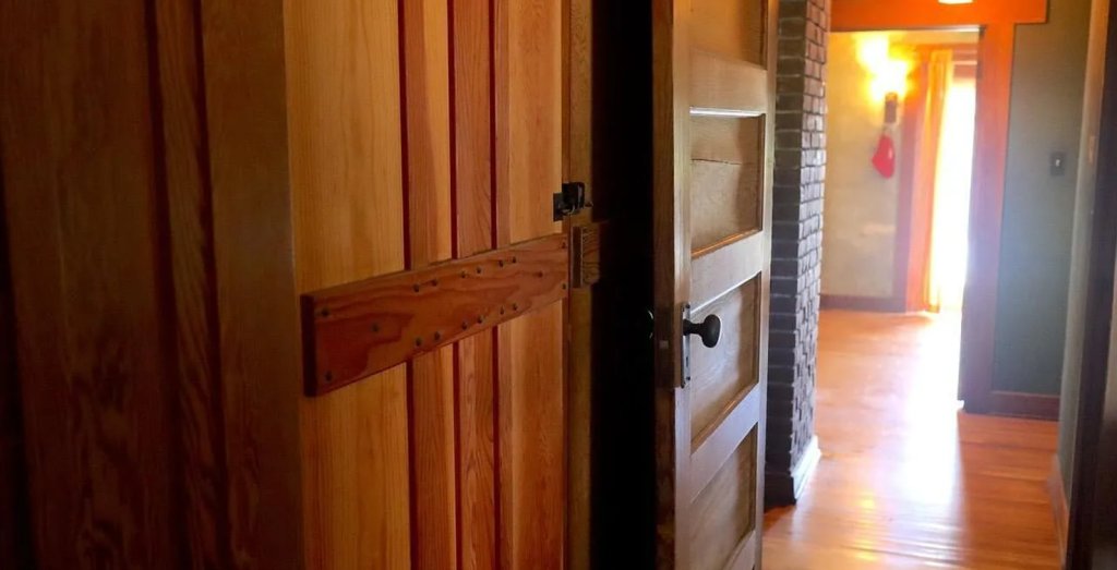 A photograph of a hallway in the Miss Lucy E. Wheeler House, showing its wood paneling and light fixtures.