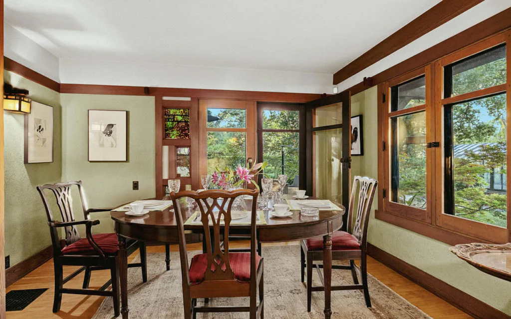 Breakfast nook in the Louise C. Bentz House with built-in seating, windows, wood table, and Arts and Crafts details