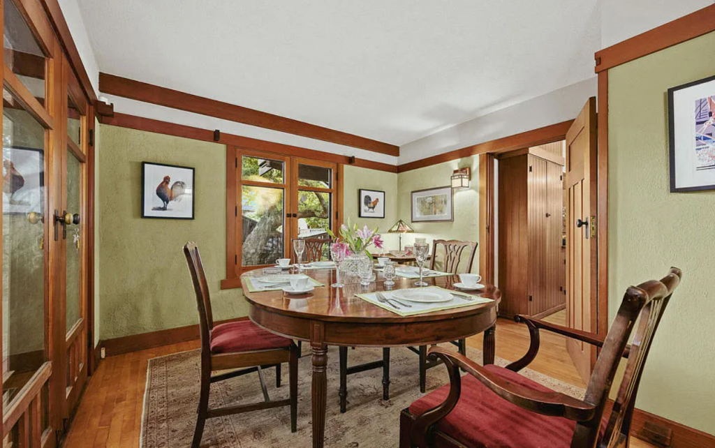 Alternate breakfast nook view of the Louise C. Bentz House showing built-in bench seating, windows, and dining area