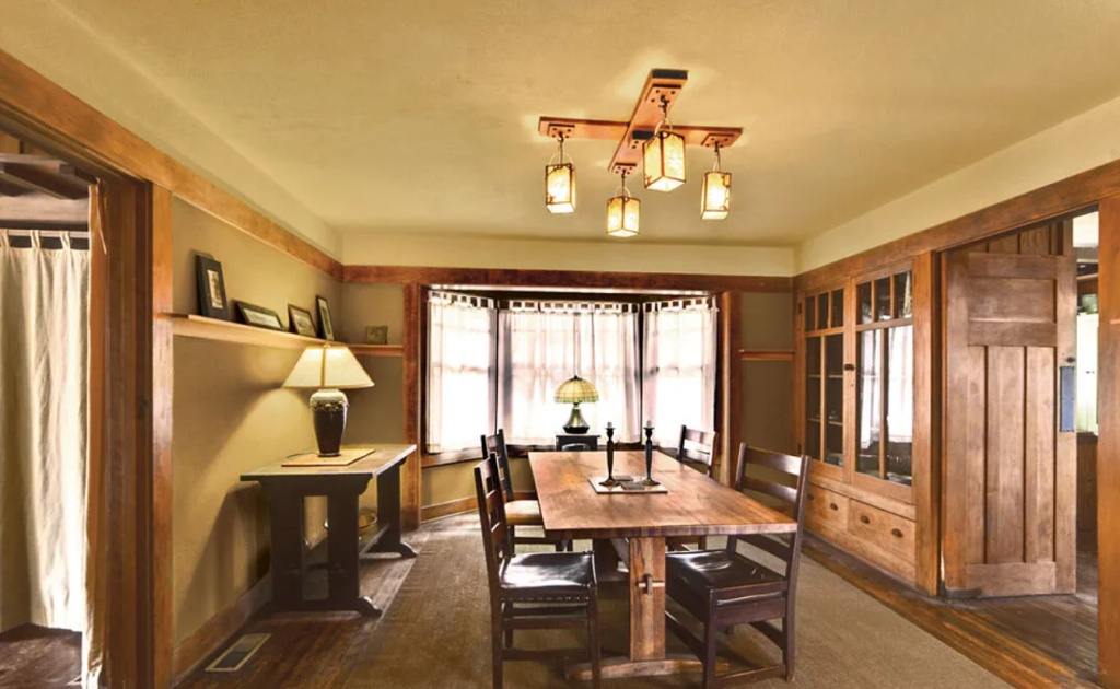 A photograph of the dining room of the Miss Lucy E. Wheeler House, showing the built-in buffet and art glass windows.