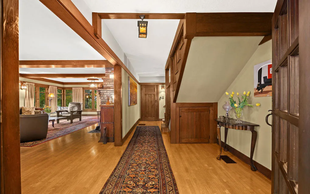 Alternate entryway view of the Louise C. Bentz House showing wood floors, staircase, and Arts and Crafts details