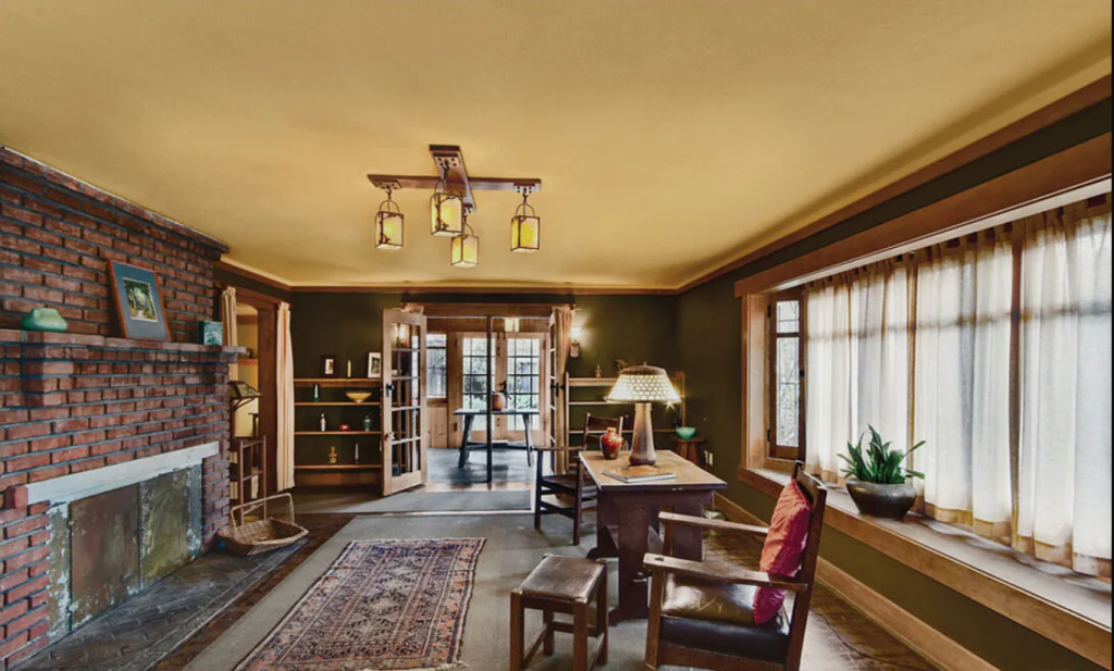 A photograph of the living room of the Miss Lucy E. Wheeler House, showing the fireplace and built-in bookcases.
