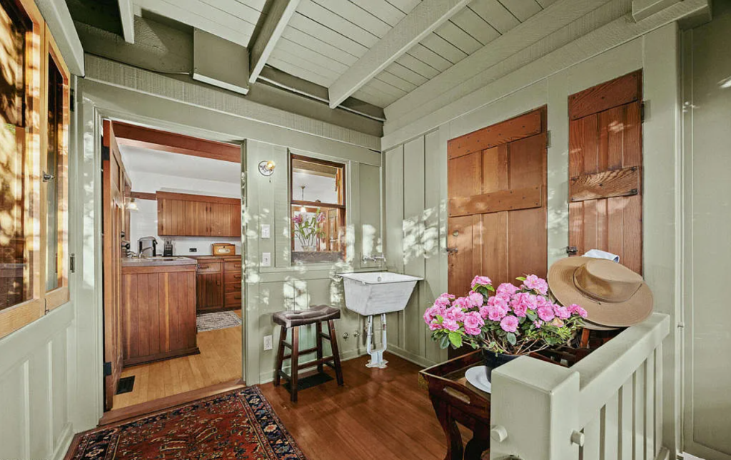 Utility room in the Louise C. Bentz House with washer, dryer, storage cabinetry, and functional workspace layout