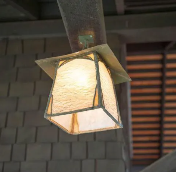 A custom-designed Arts and Crafts style hanging lantern with iridescent glass panels.