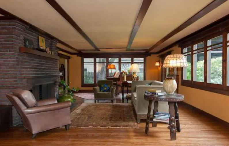 The living room of the Louise T. Halsted House, featuring wood-beamed ceilings and built-in cabinetry.