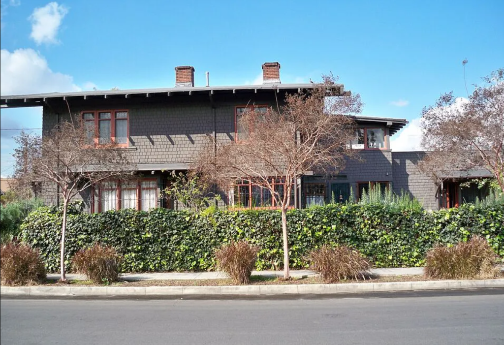 A contemporary photograph of the side of the Miss Lucy E. Wheeler House, showing its narrow form and rooflines.