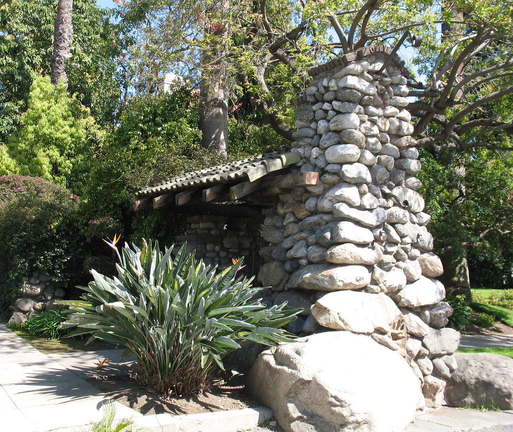 Side view of an Oaklawn portal tower and its attached lower cobblestone column and pedestrian gate