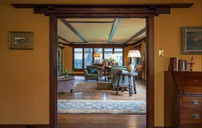 A view from the entryway looking into the living room of the Louise T. Halsted House, showing the fireplace in the distance.