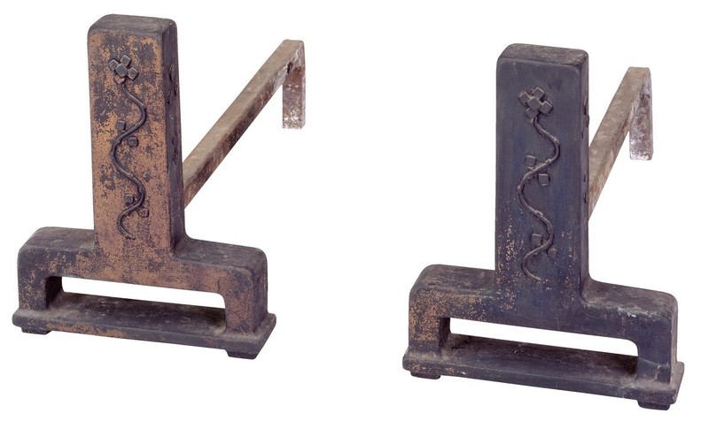 Bronze andirons with sculptural Arts and Crafts design featuring strong, simple lines and organic forms. The fireplace accessories demonstrate Greene and Greene's attention to functional objects, with casting quality and proportions that complement the hearth's brick and tile work.