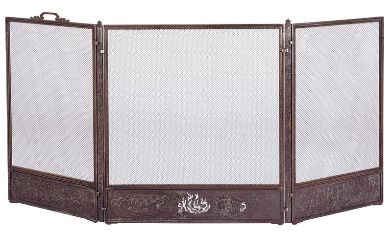 Three-panel folding fire screen in cast bronze or iron with fine mesh panels and decorative relief work along bottom sections. Features ornate floral and organic motifs in Arts and Crafts style, with central panel displaying detailed botanical design. Functional fireplace accessory elevated to decorative art through exceptional craftsmanship.