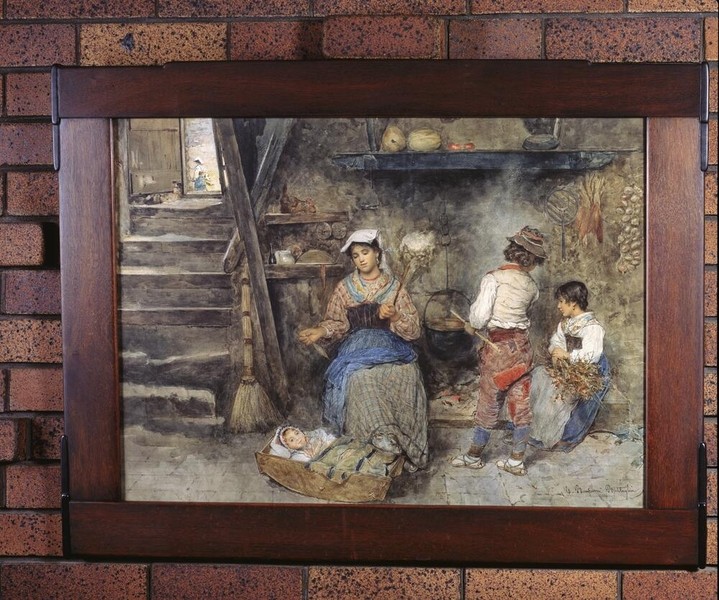 Custom-designed picture frame in Honduras mahogany holding a genre painting of figures in interior setting. The frame features characteristic Greene and Greene joinery with exposed pegs and refined proportions, integrating artwork seamlessly into the house's decorative scheme.