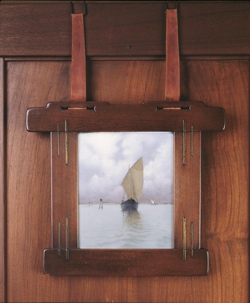 Honduras mahogany picture frame with decorative brass inlay details by Carl Schmidt. The frame exemplifies collaboration between Greene and Greene and master artisan, featuring metalwork accents that complement the wood's natural beauty and the house's integrated design.