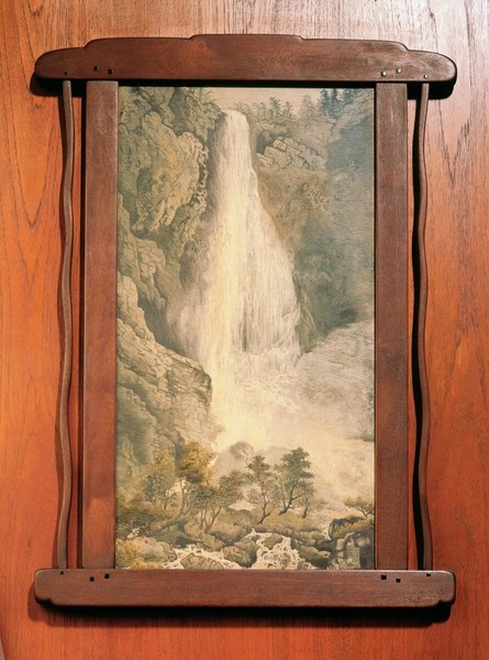 Honduras mahogany frame displaying Japanese waterfall artwork, reflecting Greene and Greene's appreciation for Japanese aesthetics. The frame's clean lines and visible joinery details complement the Asian-influenced artwork, demonstrating the architects' curatorial approach to interior decoration.