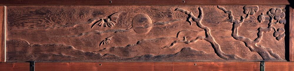 Nocturnal frieze scene featuring bats in flight beneath a full moon, with silhouetted trees in the foreground. The dramatic composition uses a darker palette to evoke evening atmosphere, adding variety to the continuous landscape narrative.