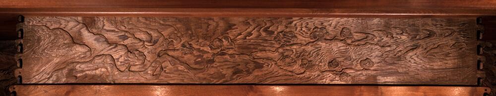 Frieze panel depicting tree branches silhouetted against a cloudy sky. The composition features atmospheric perspective with soft cloud formations and organic branch forms, creating a contemplative connection between interior and exterior natural elements.