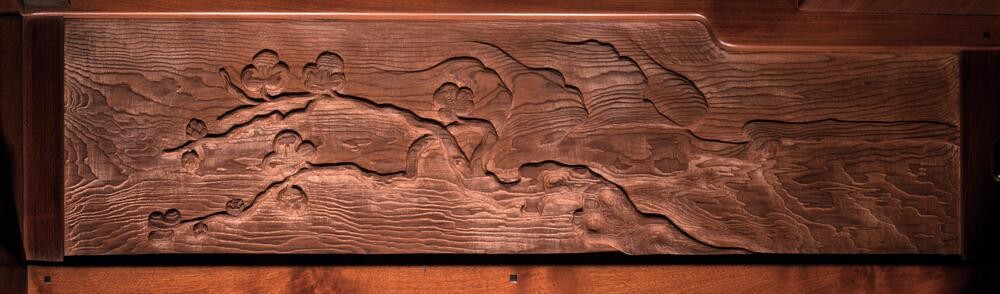 Detailed frieze panel depicting a single tree branch with delicate foliage extending diagonally across the composition. The naturalistic rendering shows careful observation of plant forms, painted in subtle earth tones that harmonize with the room's woodwork.