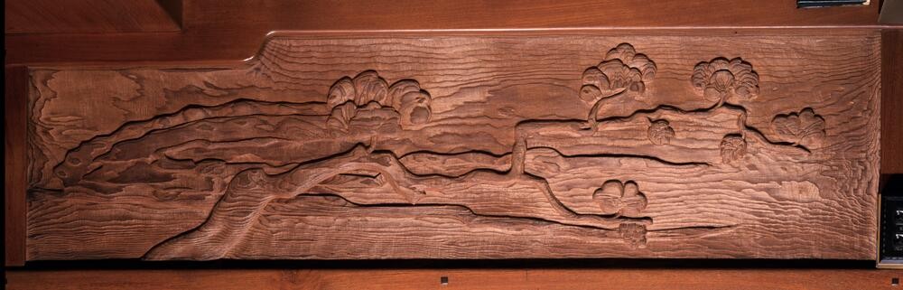 Detailed frieze panel depicting a single tree branch with delicate foliage extending diagonally across the composition. The naturalistic rendering shows careful observation of plant forms, painted in subtle earth tones that harmonize with the room's woodwork.
