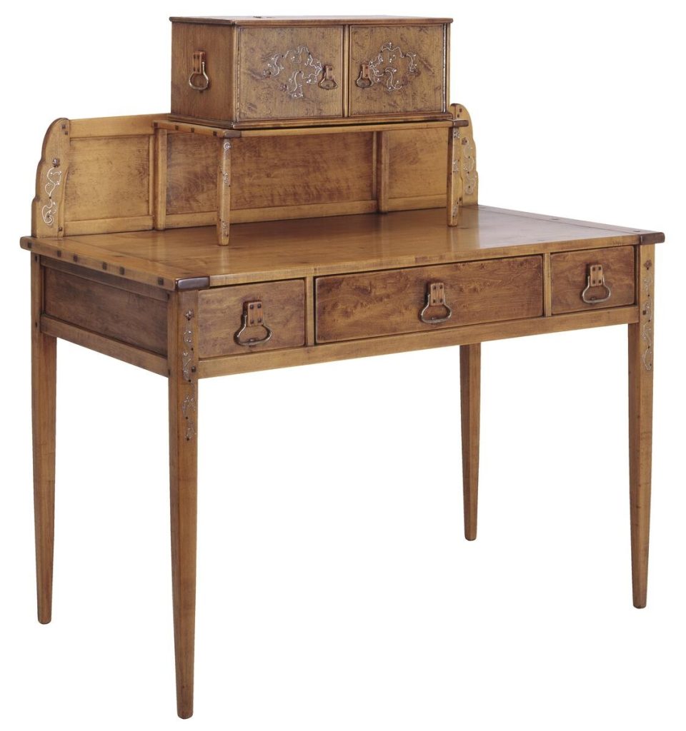 Greene and Greene designed writing desk from the Gamble House crafted by Peter Hall Manufacturing Company in Honduras mahogany and bird's-eye maple, featuring a raised letter box compartment with three small drawers decorated with silver inlay depicting stylized vines, a slant-front writing surface with decorative end panels featuring silver inlay of organic motifs, three main drawers with cloud-lift copper pulls, tapered legs with square ebony pegs securing all joinery, and the characteristic rounded edges and meticulous craftsmanship that exemplify the brothers' furniture design for the ultimate bungalows