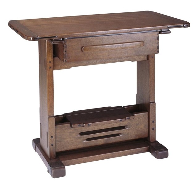 Greene and Greene designed serving table from the Gamble House dining room crafted by Peter Hall Manufacturing Company in Honduras mahogany, featuring a rectangular top with rounded corners, copper and leather strap hardware at the corners, a single drawer with cloud-lift copper pull, lower shelf with horizontal slat design for storage, massive slab legs with square ebony pegs, and the characteristic rounded edges and exposed joinery that exemplify the ultimate bungalow furniture aesthetic
