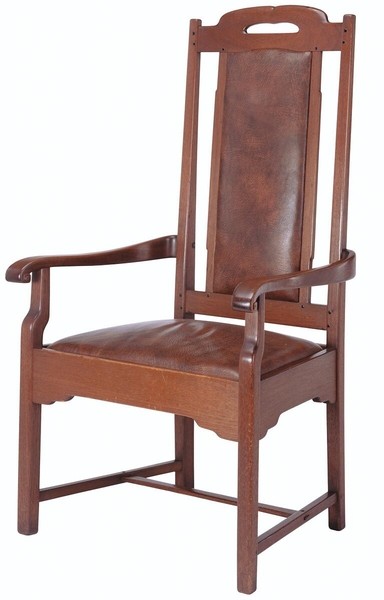 Arts and Crafts hall chair in Honduras mahogany with high back and broad armrests. Features original brown leather upholstery on seat and back panel, carved handle cutout in crest rail, and simple vertical slat design. Exemplifies Greene and Greene's integration of comfort and craftsmanship.