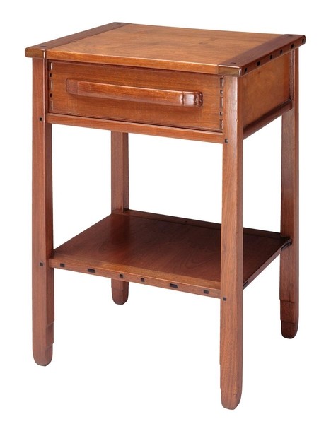 Greene and Greene designed nightstand from the Gamble House crafted by Peter Hall Manufacturing Company in Honduras mahogany and black walnut, featuring a single drawer with cloud-lift copper pull and figured black walnut drawer front, lower shelf for storage, tapered legs with square ebony pegs securing all joinery, and the characteristic rounded edges and exposed structural elements that exemplify the ultimate bungalow furniture aesthetic