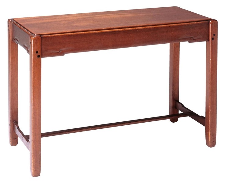 Piano bench in Honduras mahogany with lift-top storage compartment. Features rounded corner details, tapered legs with cloud-lift brackets, lower stretcher for stability, and visible pegging. Simple, elegant form demonstrates Greene and Greene's ability to elevate utilitarian furniture through refined craftsmanship.