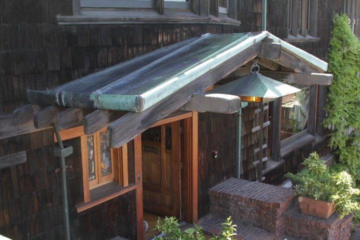 Aerial view of Thorsen House front entrance showing timber gable, copper flashing, hanging lantern, and brick terrace