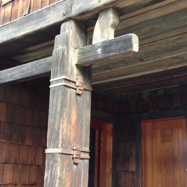 Thorsen House sun deck support beams showing timber construction, corbels, metal straps, and structural joinery details