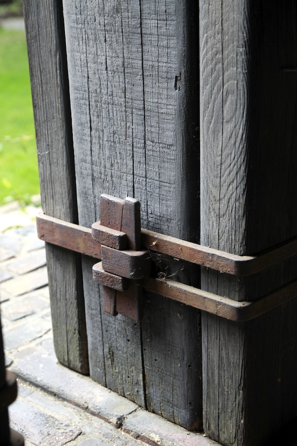 Close-up of Thorsen House sun deck timber support beams with metal collar straps, wedges, and Greene & Greene detailing