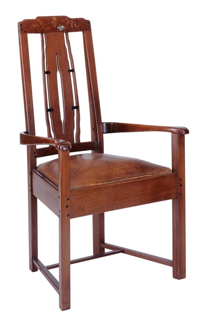 Greene & Greene armchair for Thorsen House with inlaid back splat, vertical slats, leather seat, and ebony pegs