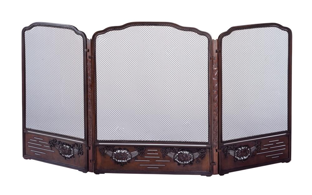 Greene & Greene dining room fireplace screen for Thorsen House with mesh panels, carved floral motifs, and mahogany frame