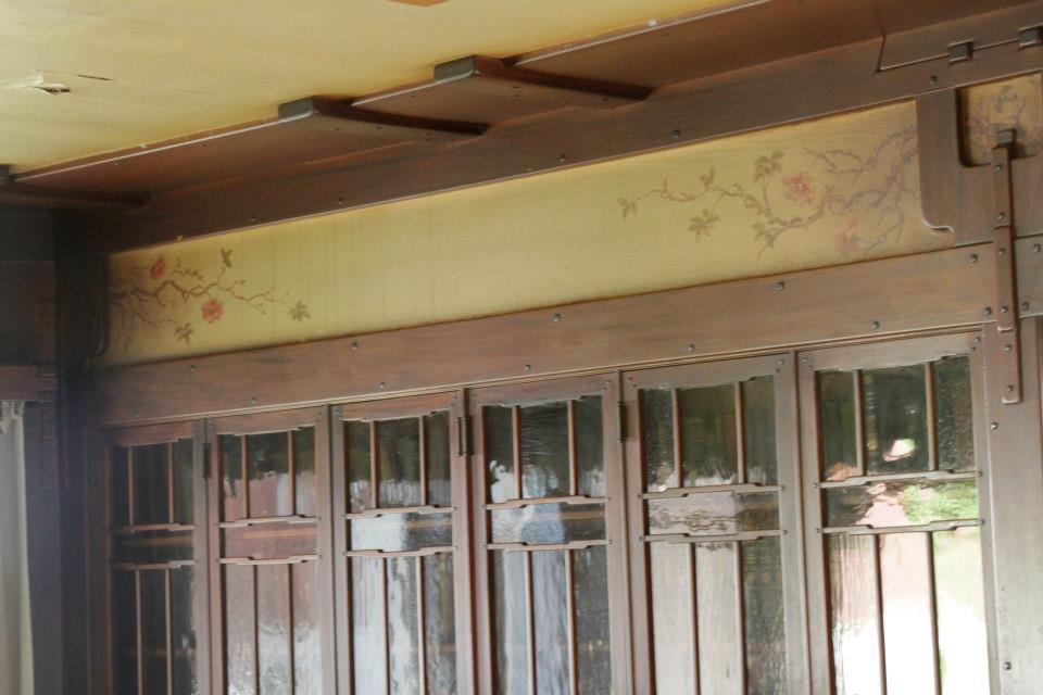 Detail of Thorsen House built-in bookcases with glass doors, Charles Greene painted frieze with trailing roses above