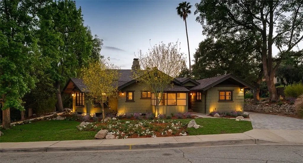 Front exterior of Edgar W. Camp house showing Craftsman bungalow with shingle siding and landscaped garden at dusk