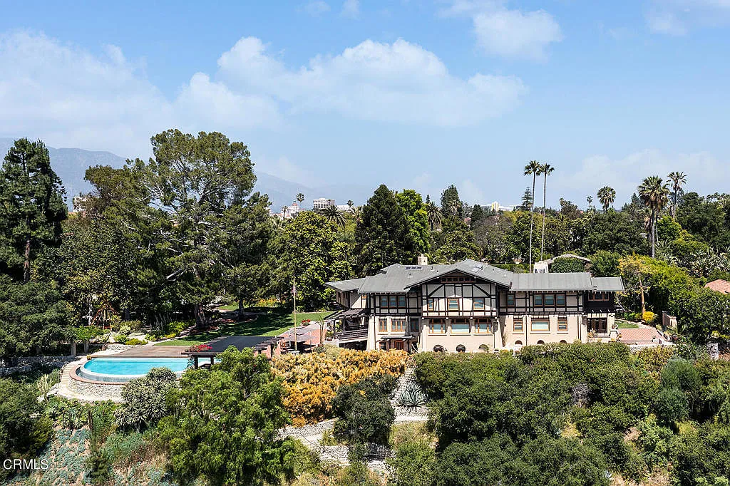 Overhead view of the Laurabelle A. Robinson House backyard with swimming pool, patio, wisteria pergola, and canyon views