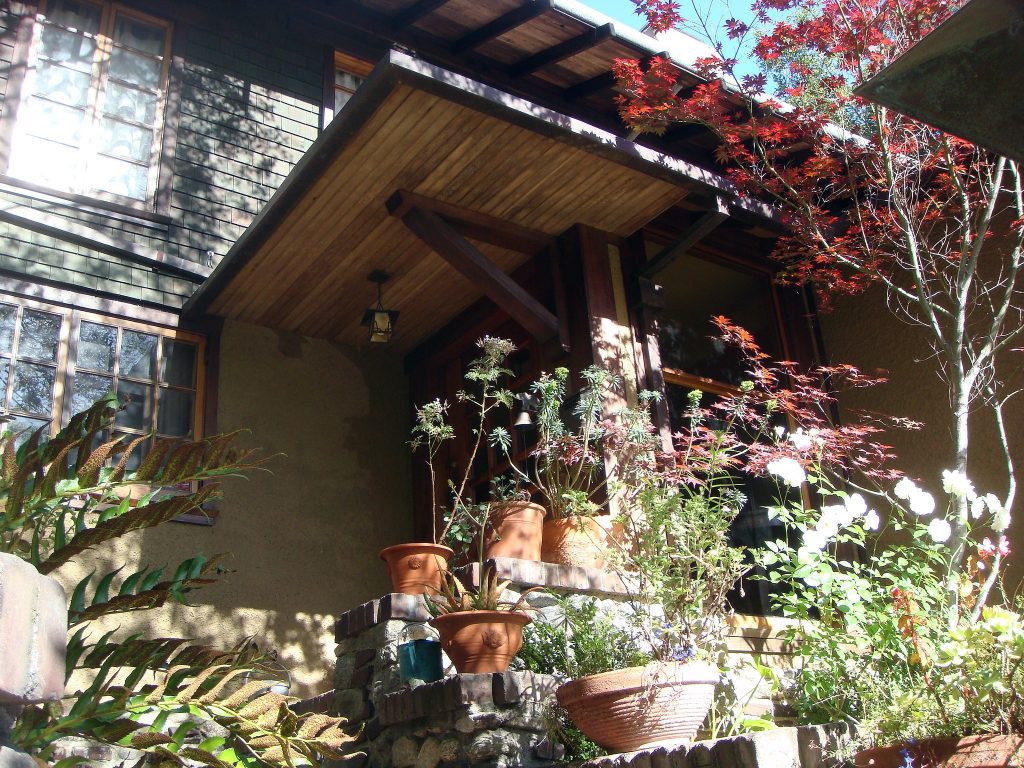 Front entrance of Charles S. Greene House featuring Arts and Crafts design elements and natural wood detailing