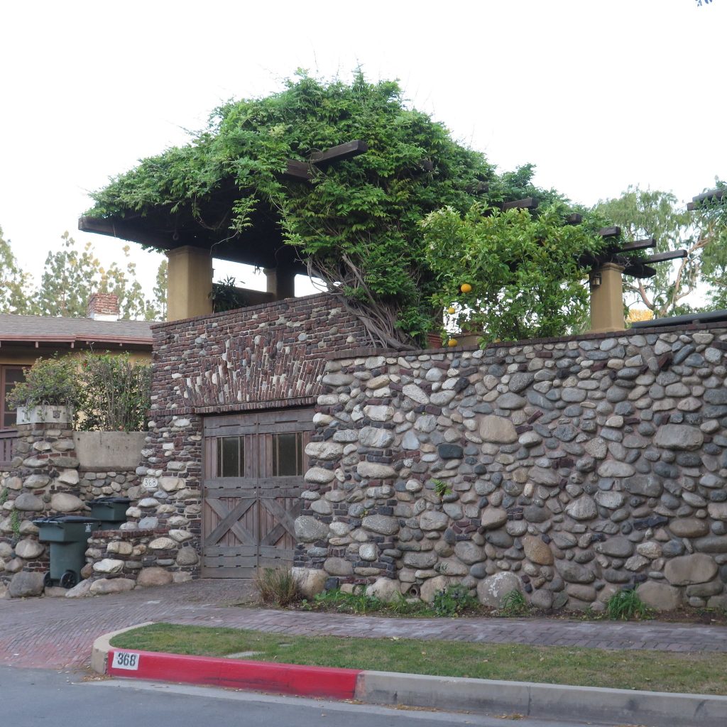 Alternate view of 1914 garage with clinker brick, cobblestones, and plaster-coated piers at Charles S. Greene House