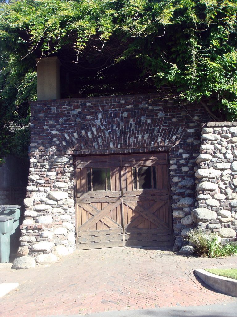 Front facade of Charles S. Greene House garage with distinctive clinker brick and cobblestone construction