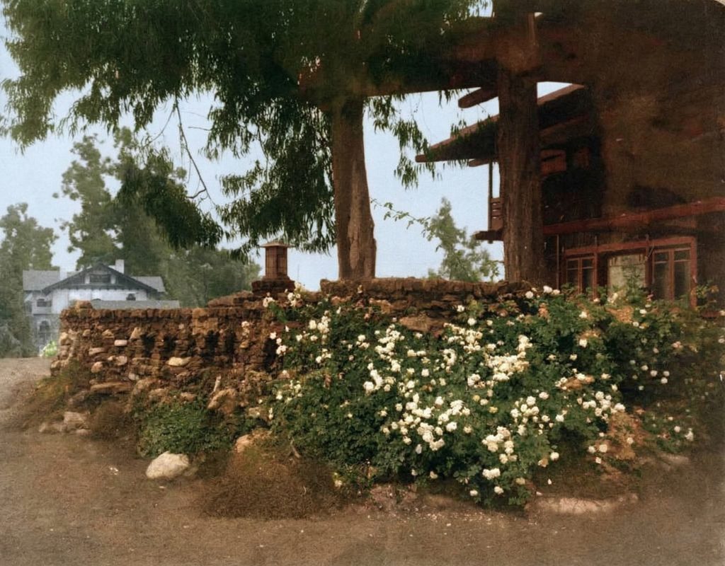 Historic colorized photograph from circa 1908-1910 showing the rear terrace area of the Gamble House.